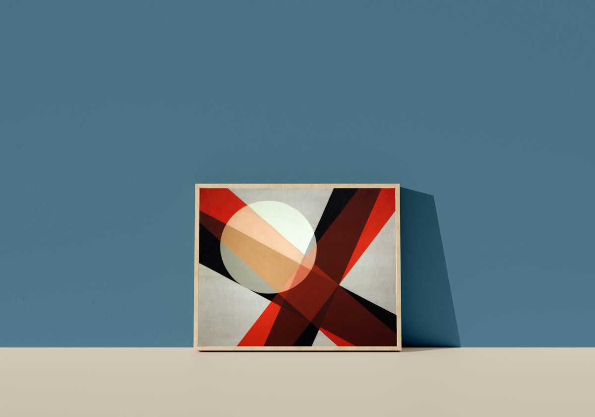 Framed art print of A 19 by László Moholy-Nagy, in a light wood frame leaning on a blue wall