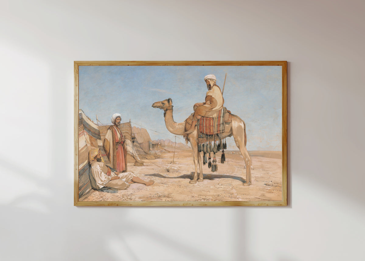 Framed art print of A Bedouin Encampment; or, Bedouin Arabs by John Frederick Lewis, in a light wood frame on a sunlit white wall