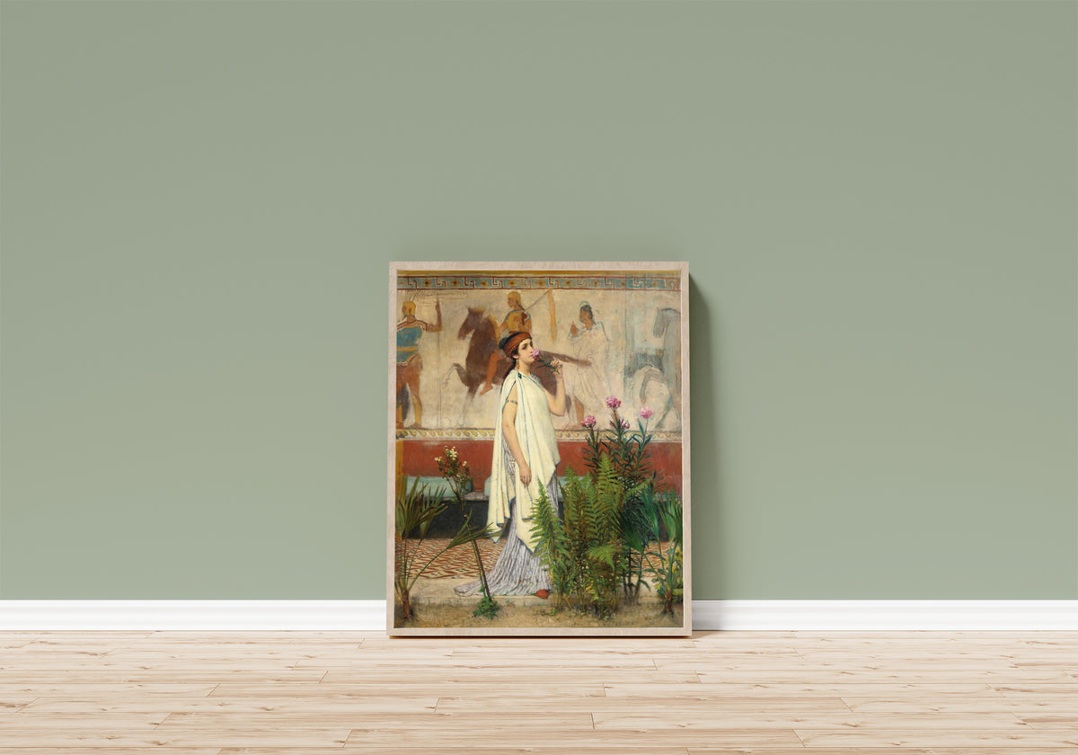 Framed art print of A Greek Woman by Lawrence Alma-Tadema, in a light wood frame leaning on a sage green wall above a wooden floor