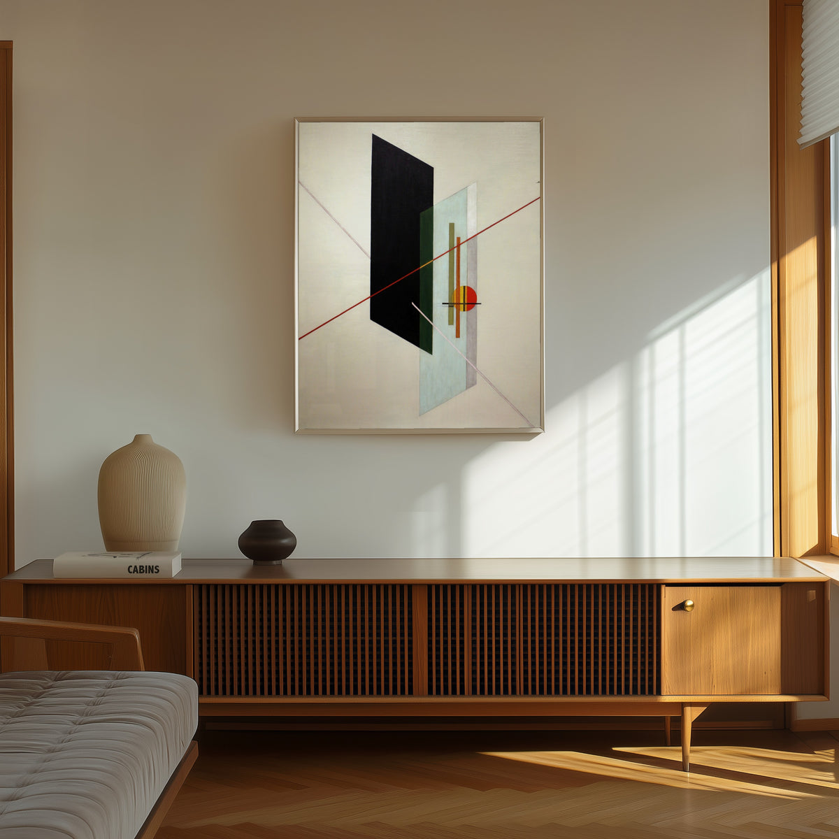Framed art print of A IX by László Moholy-Nagy, in a thin light frame on a sunlit wall above a wooden sideboard