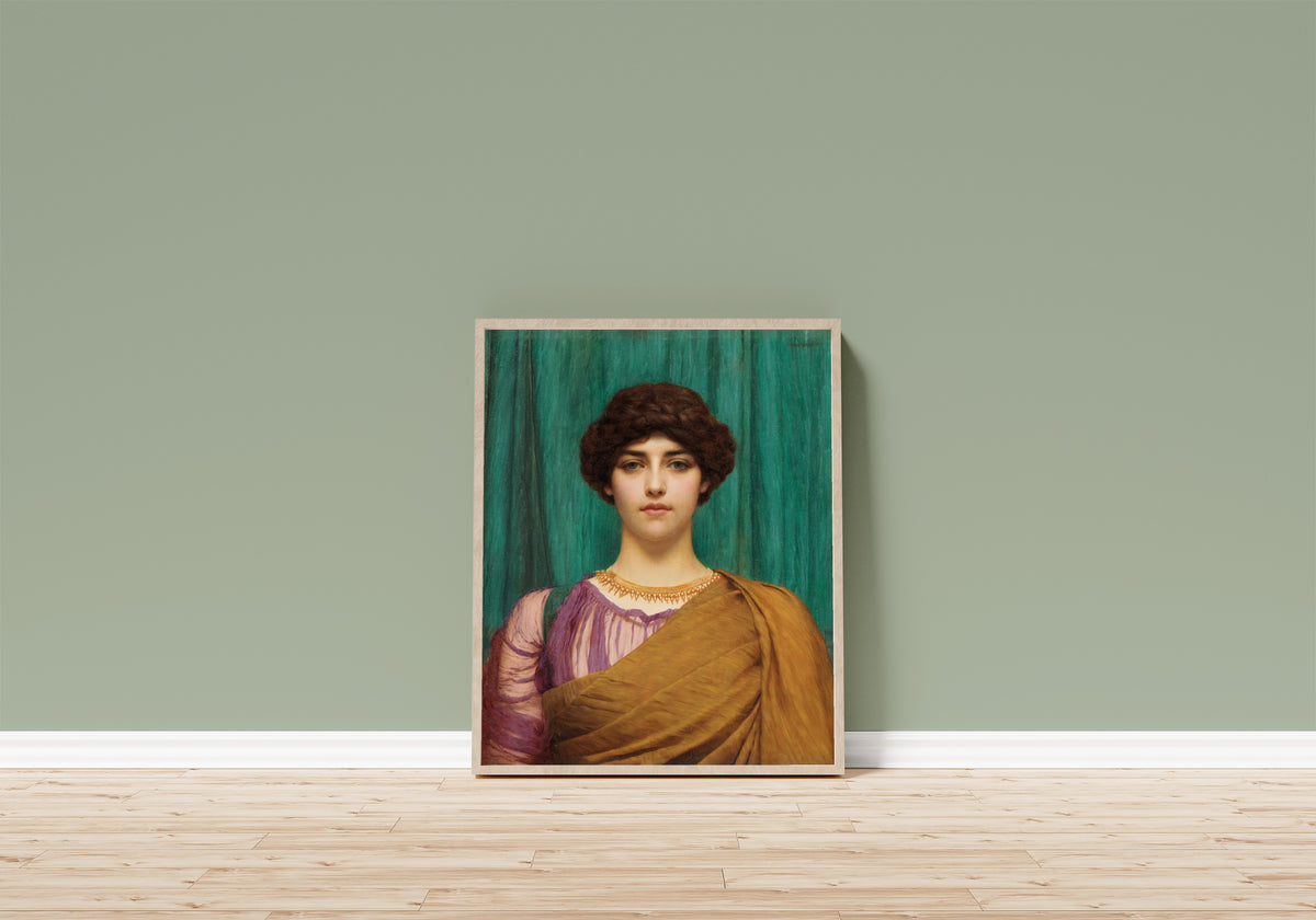 Framed art print of A Pompeian Lady by John William Godward, in a light wood frame leaning on a sage green wall above a wooden floor