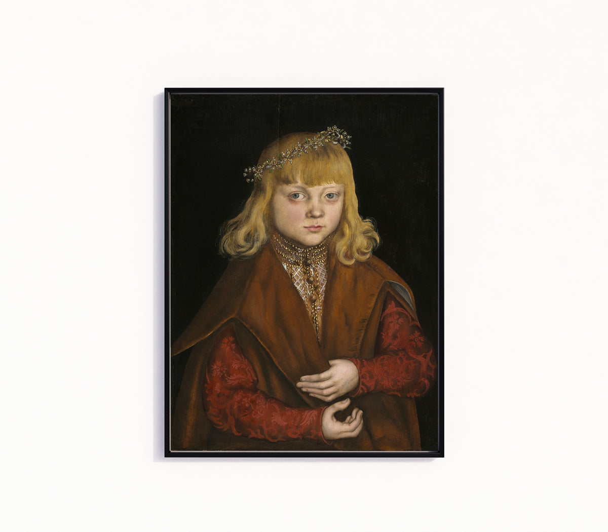 Framed art print of A Prince of Saxony by Lucas Cranach the Elder, in a slim black frame on a plain white wall