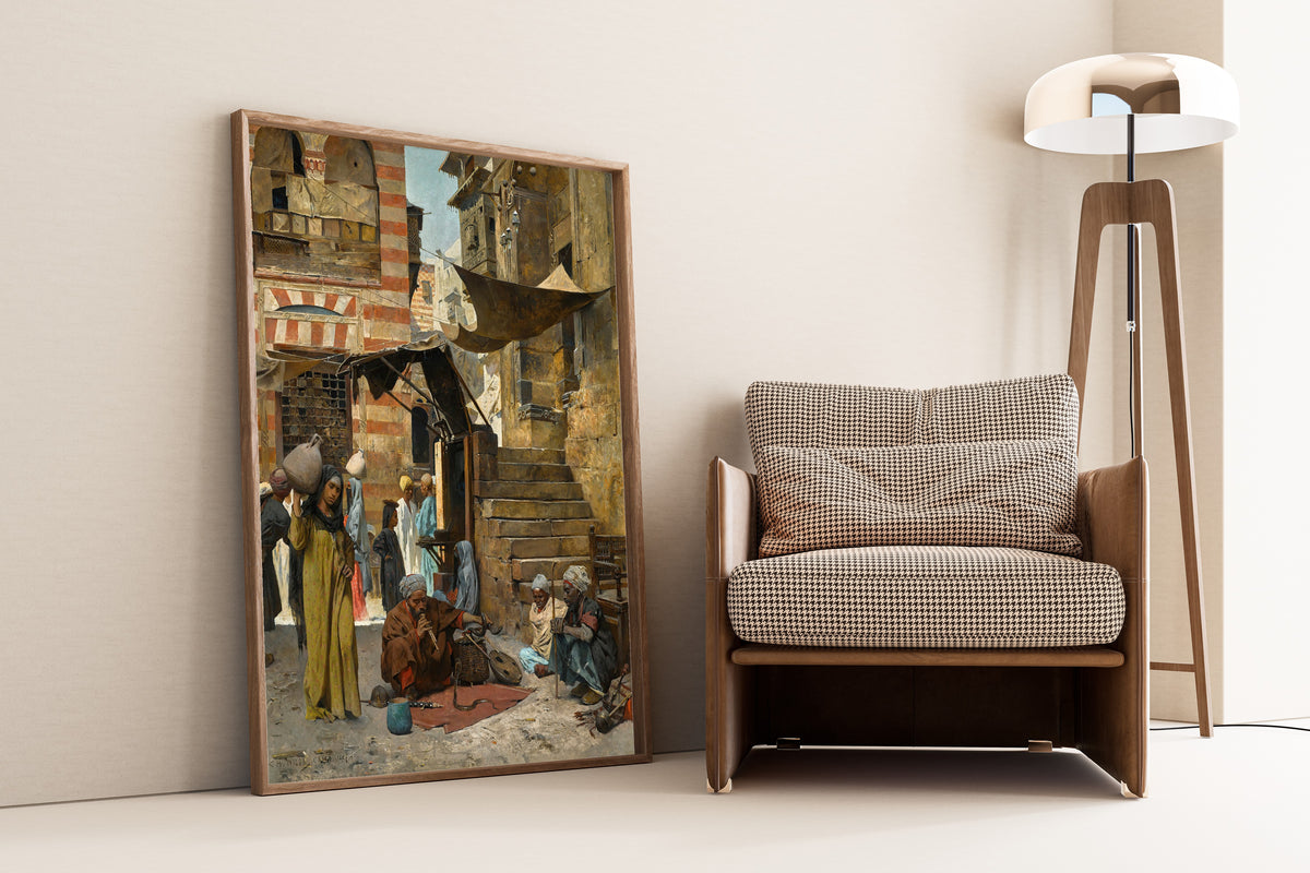 A Souk in Cairo by Charles Wilda — framed and leaning against a wall beside an armchair and a floor lamp
