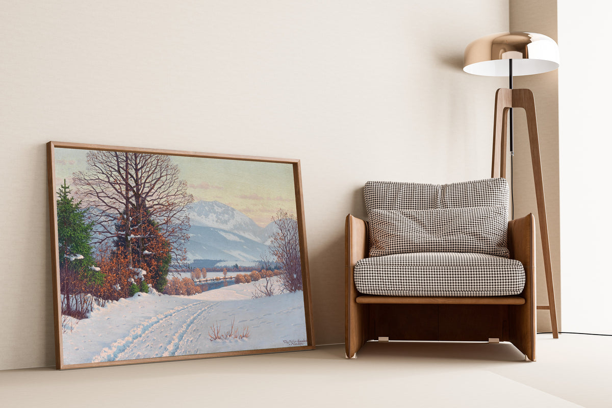 A Sunny Winter Day by Fritz Müller-Landeck — framed and leaning against a wall beside an armchair and a floor lamp