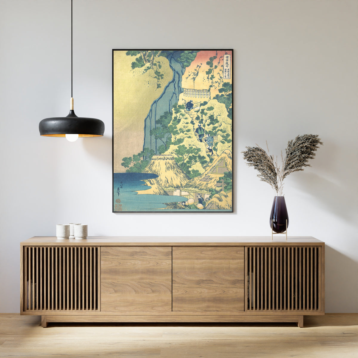 Framed art print of A Tour of the Waterfalls of the Provinces: Kiyotaki Kannon Waterfall at Sakanoshita… by Katsushika Hokusai, above a slatted wood sideboard