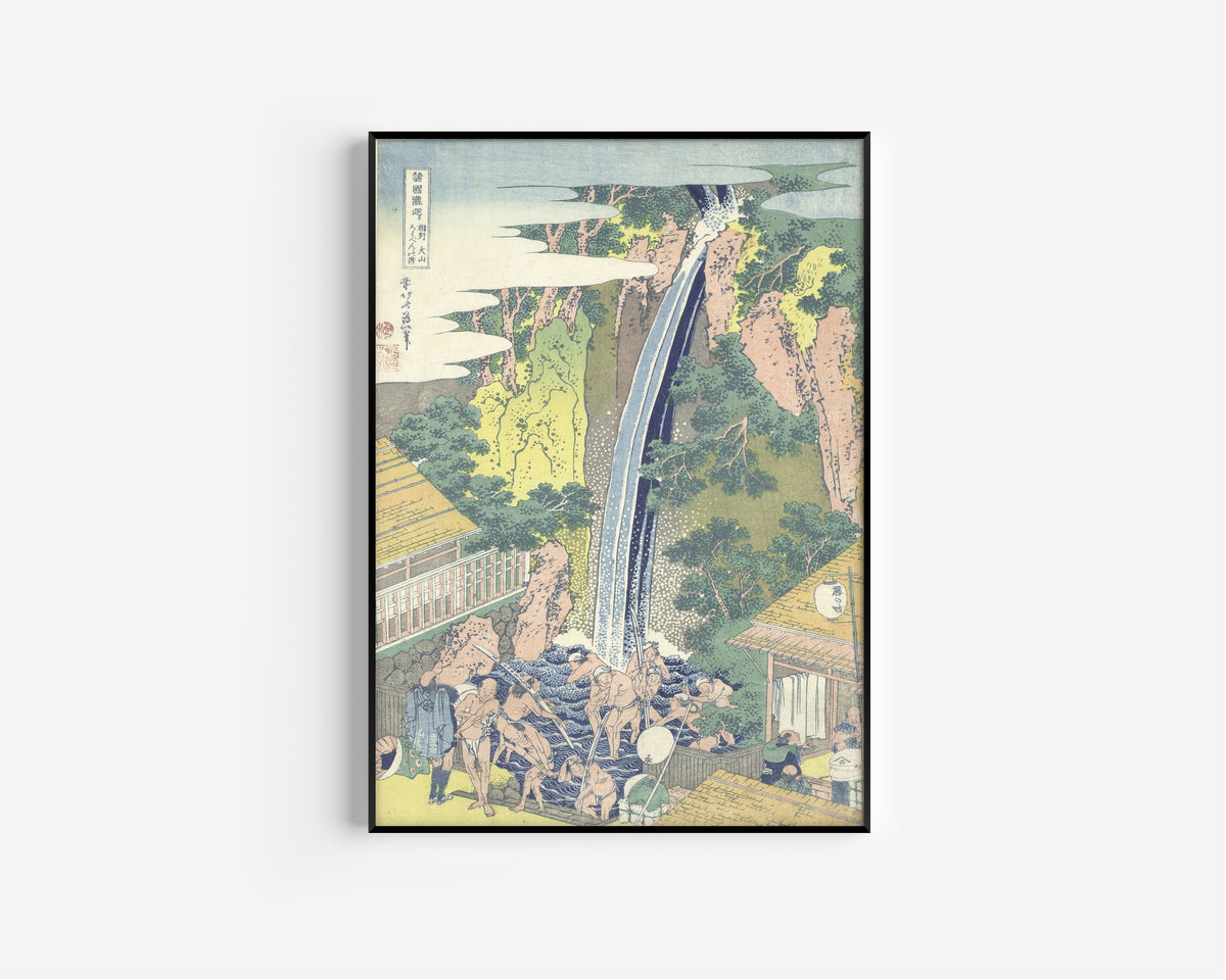 Framed art print of A Tour of the Waterfalls of the Provinces: Rōben Waterfall at Ōyama in… by Katsushika Hokusai, in a slim black frame on a plain white wall