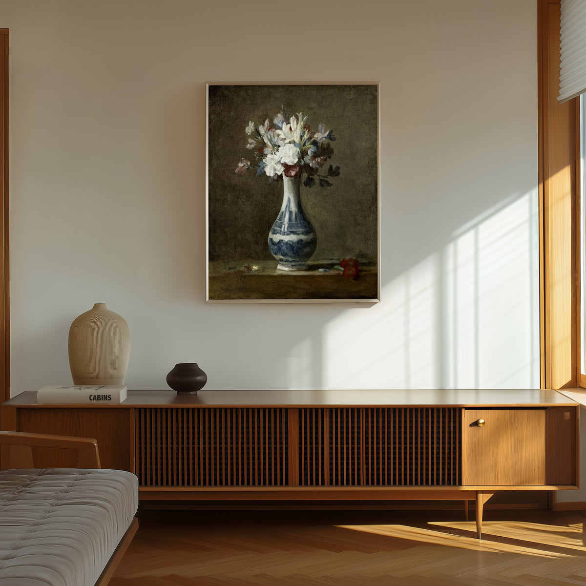 Framed art print of A Vase of Flowers by Jean-Siméon Chardin, in a thin light frame on a sunlit wall above a wooden sideboard