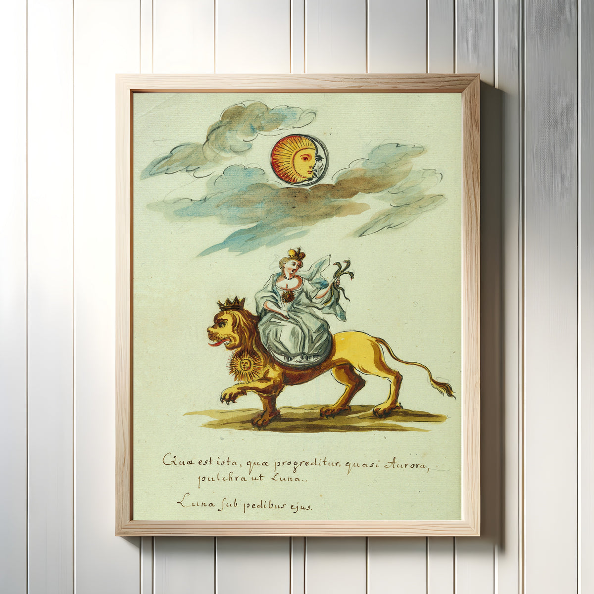 Framed art print of A Woman Seated on a Lion beneath Sun and Moon by Thesaurus Thesaurorum, in a light wood frame on a white panelled wall