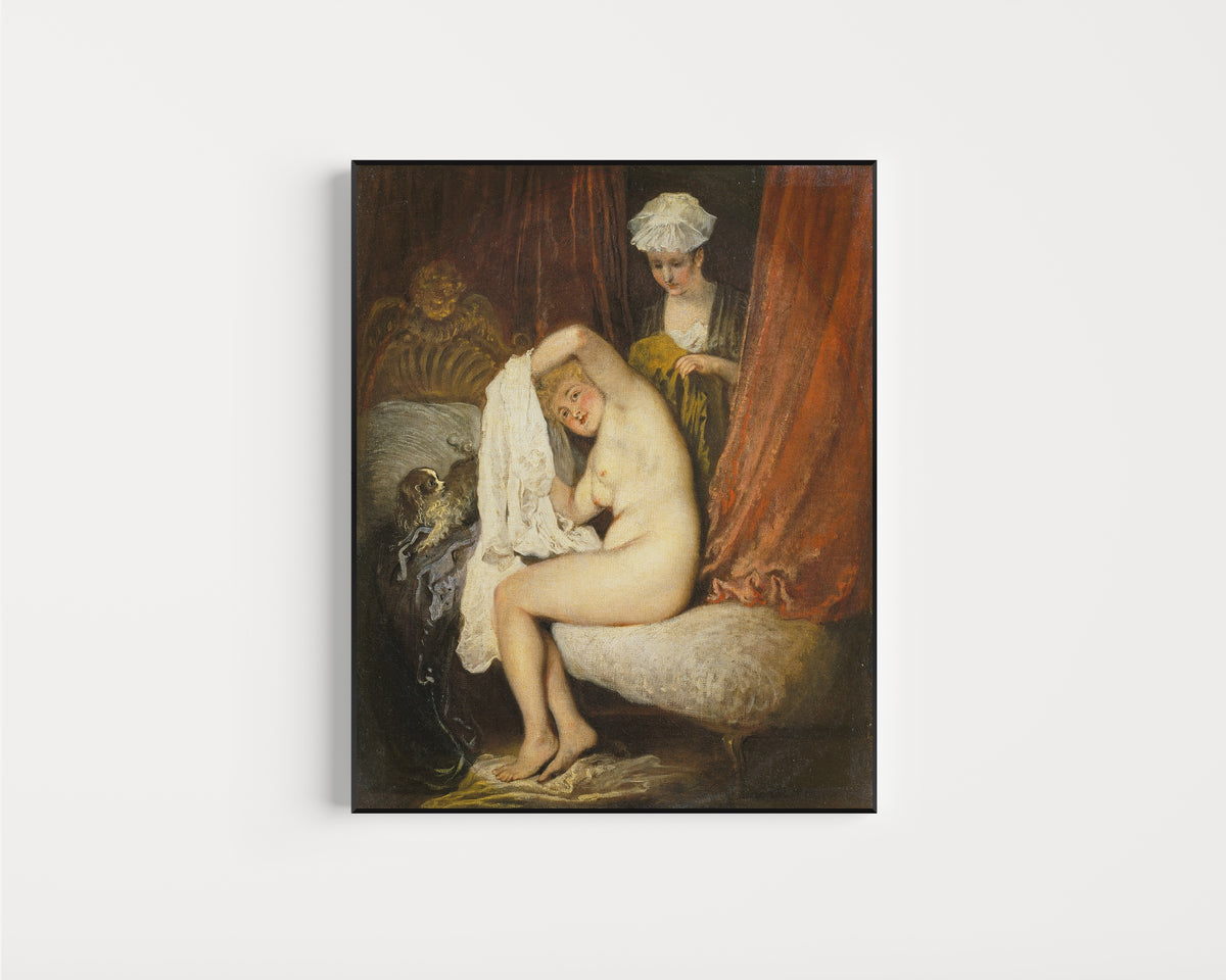 Framed art print of A Woman at Her Toilet by Jean-Antoine Watteau, in a slim black frame on a plain white wall