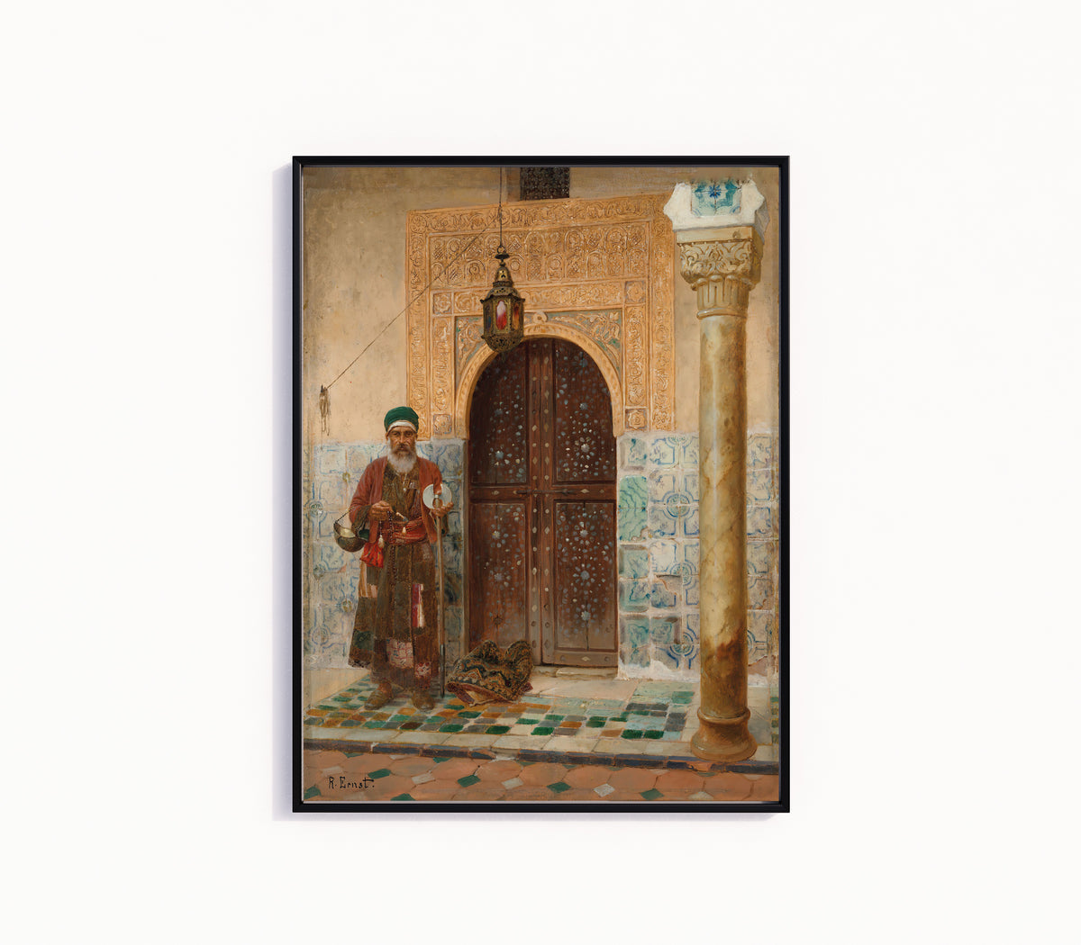 Framed art print of A holy man by an entrance by Rudolf Ernst, in a slim black frame on a plain white wall