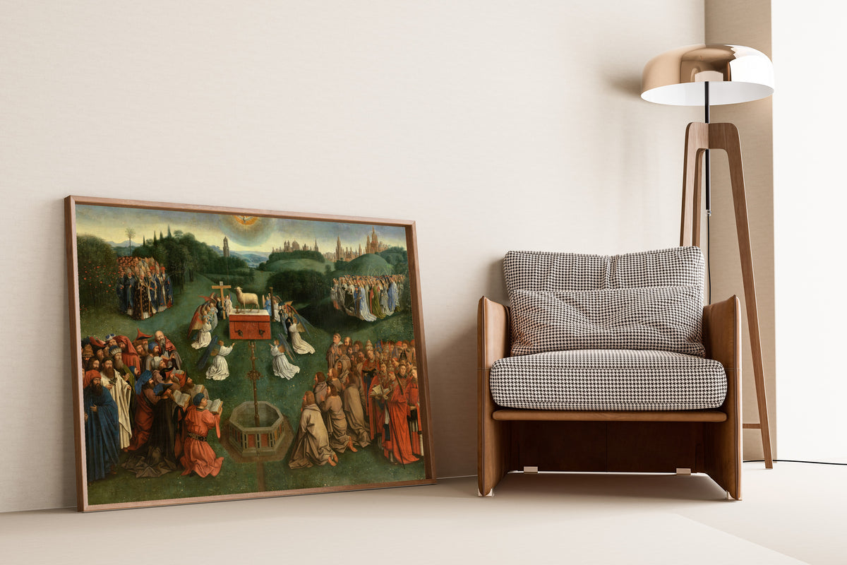 Framed art print of Adoration of the Lamb by Jan van Eyck, leaning against a wall beside an armchair and a floor lamp