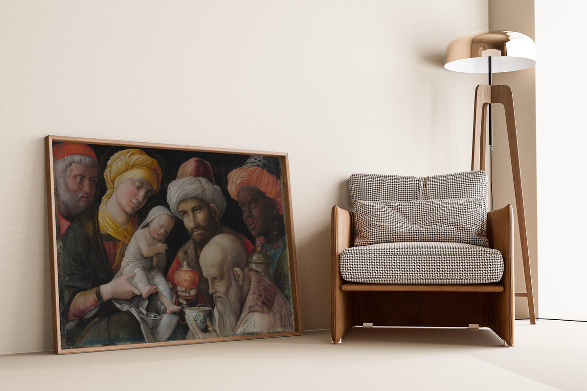 Framed art print of Adoration of the Magi by Andrea Mantegna, leaning against a wall beside an armchair and a floor lamp