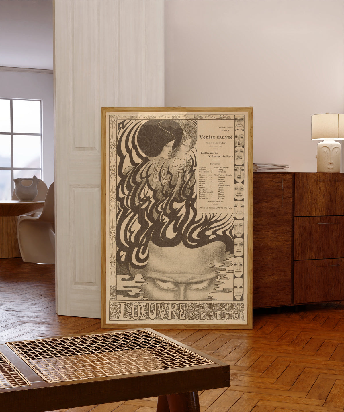 Framed art print of Affiche voor het toneelstuk Vénise sauvée van Thomas Otway by Jan Toorop, in a light wood frame leaning in a warm room with a parquet floor