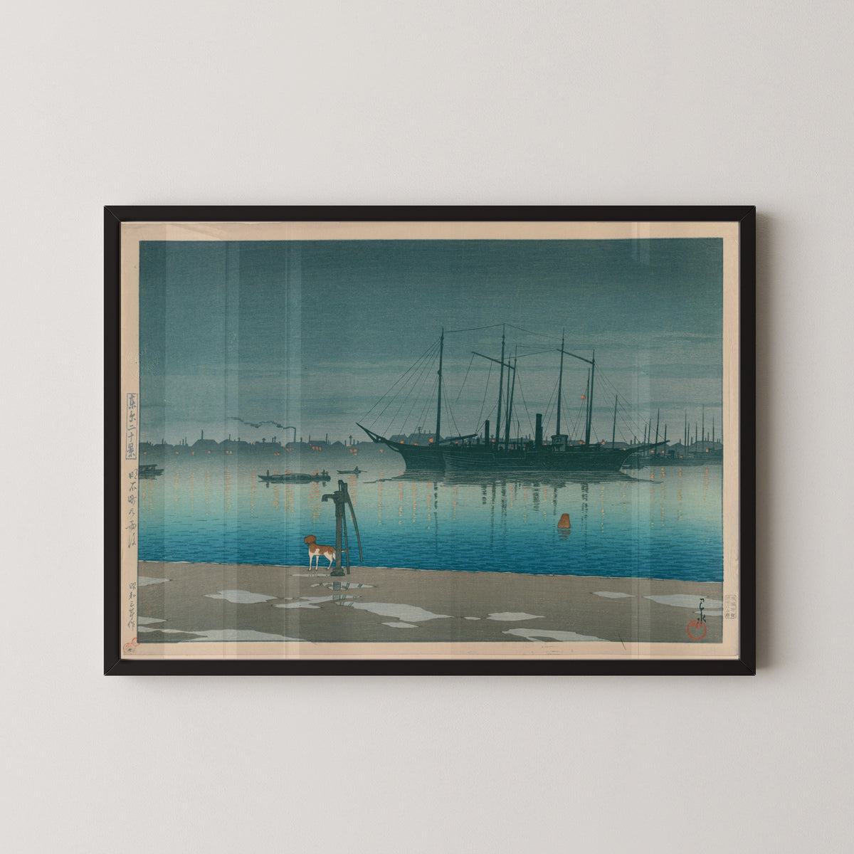 Framed art print of Akashi-cho After Rain by Kawase Hasui, in a black frame on a pale wall