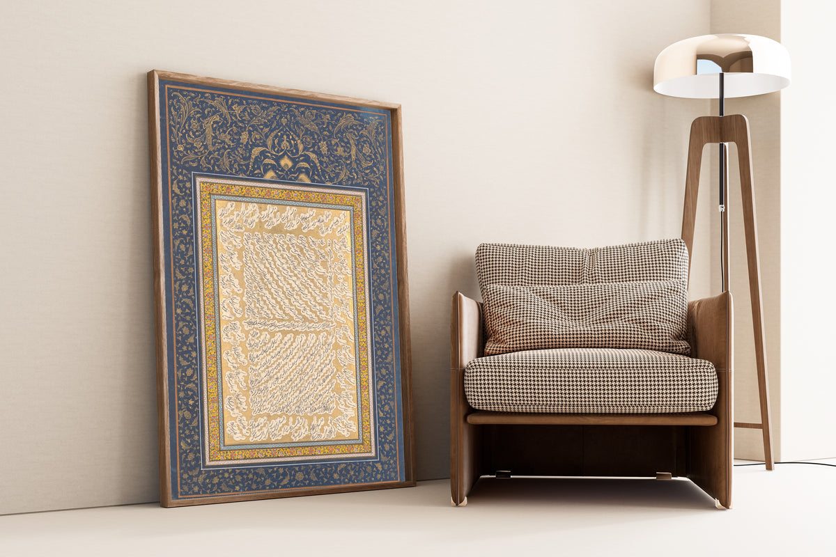 Framed art print of Album Leaf of Shekasteh-ye Nasta'liq by Mirza Kuchak, leaning against a wall beside an armchair and a floor lamp