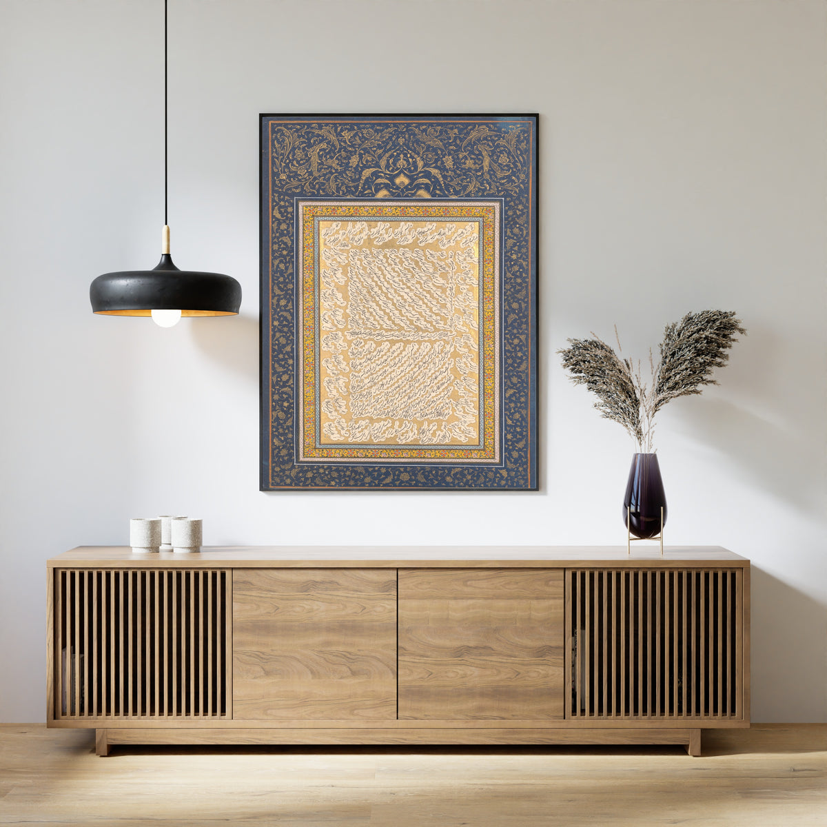 Framed art print of Album Leaf of Shekasteh-ye Nasta'liq by Mirza Kuchak, above a slatted wood sideboard