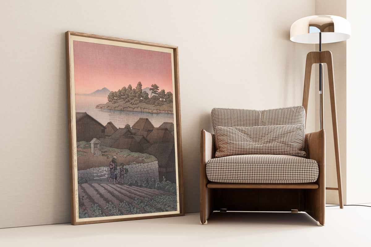 Framed art print of Amakusa Honryo by Kawase Hasui, leaning against a wall beside an armchair and a floor lamp