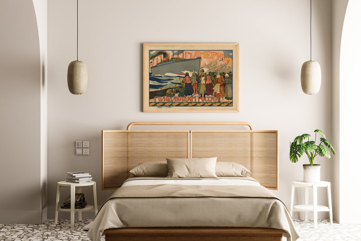 Framed art print of America to the Starving of Russia, above a cane-headboard bed