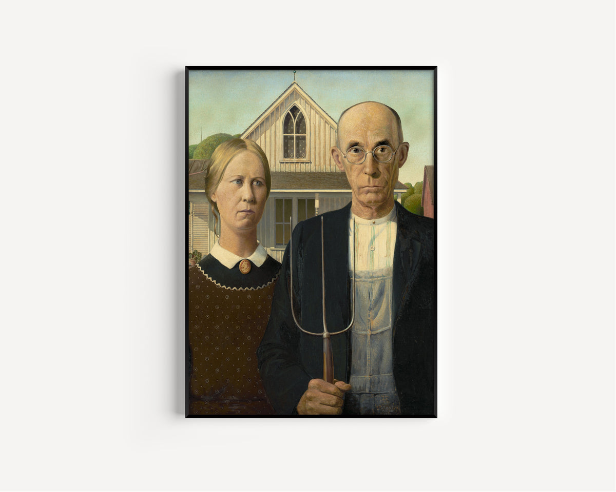American Gothic by Grant Wood — in a slim black frame on a plain white wall