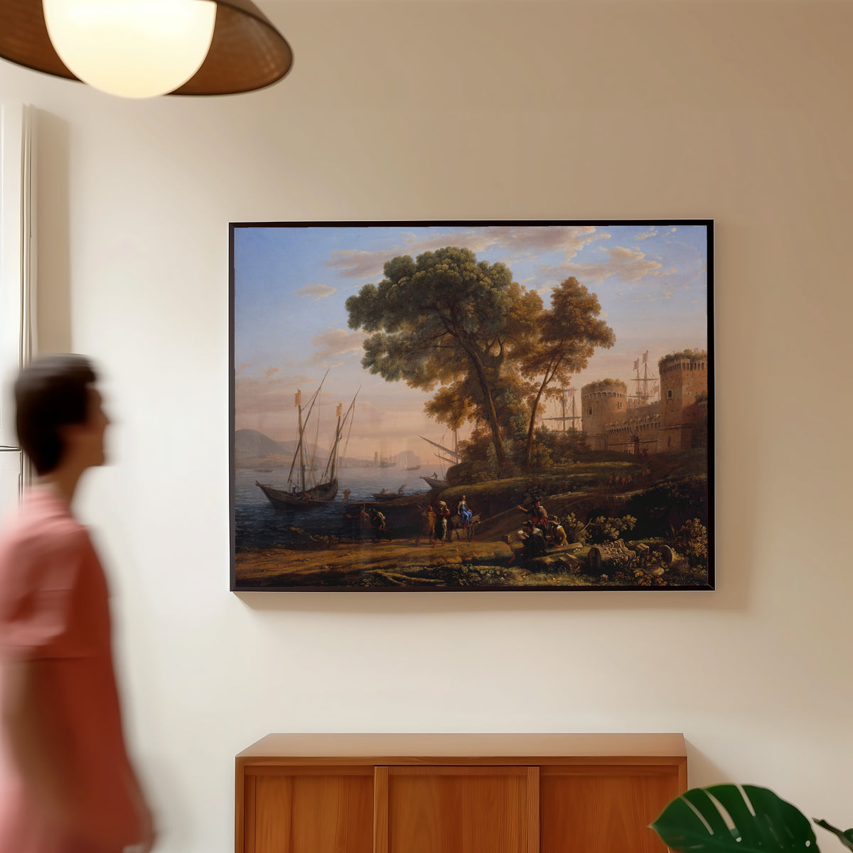 Framed art print of An Artist Studying from Nature by Claude Lorrain, in a slim black frame on a warm wall in a sunlit room