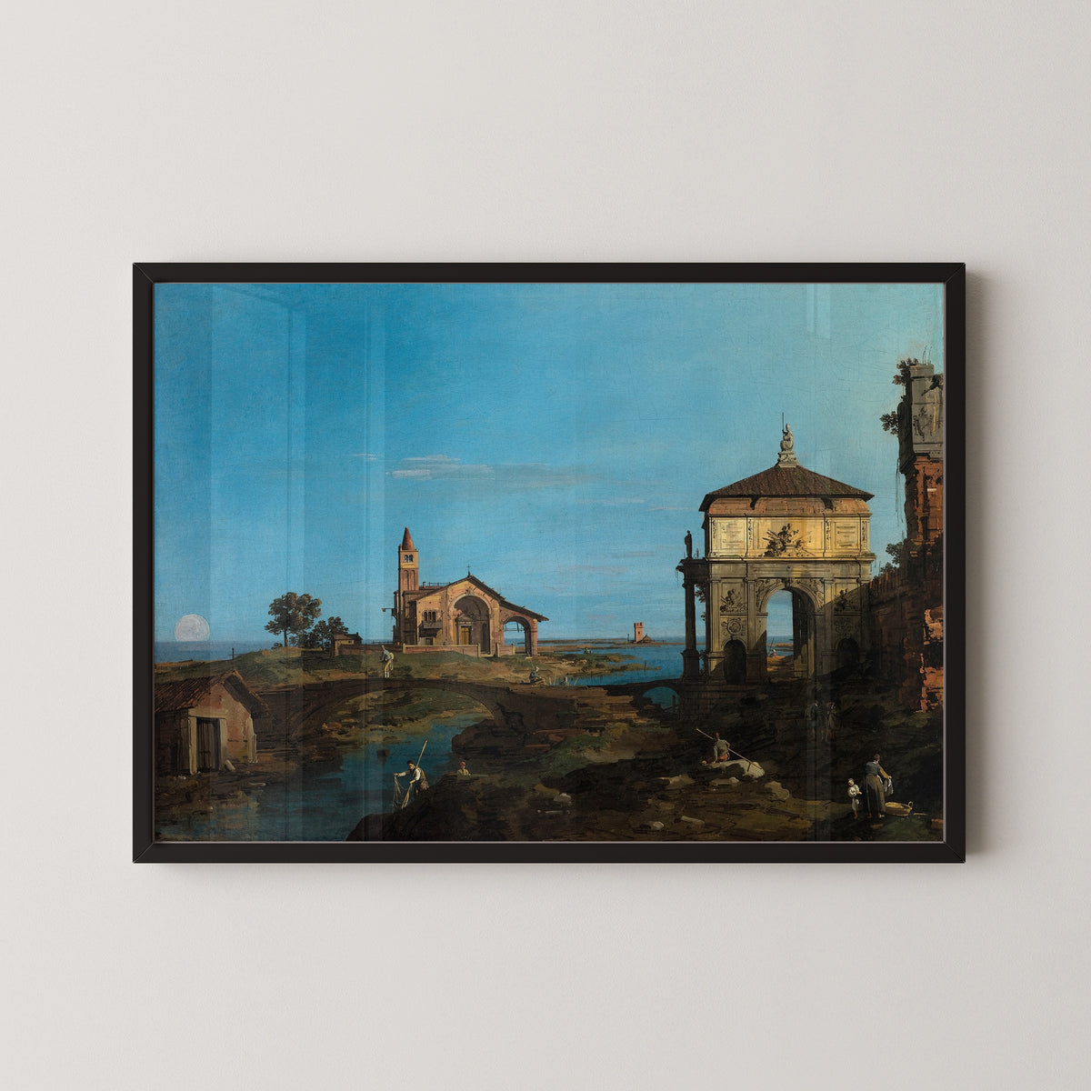 Framed art print of An Island in the Lagoon with a Gateway and a Church by Canaletto, in a black frame on a pale wall