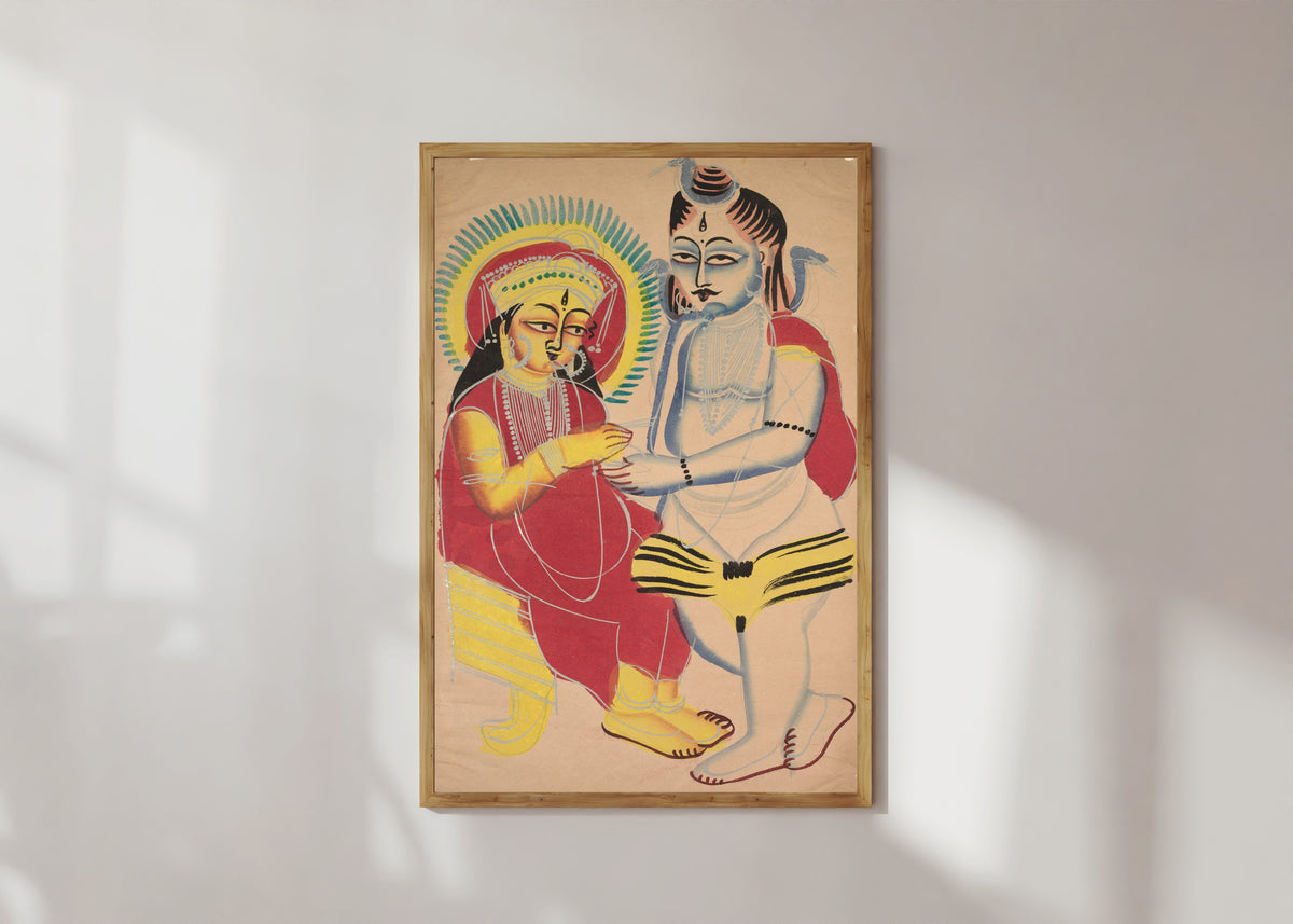 Framed art print of Annapurna and Shiva by Kalighat painter, in a light wood frame on a sunlit white wall