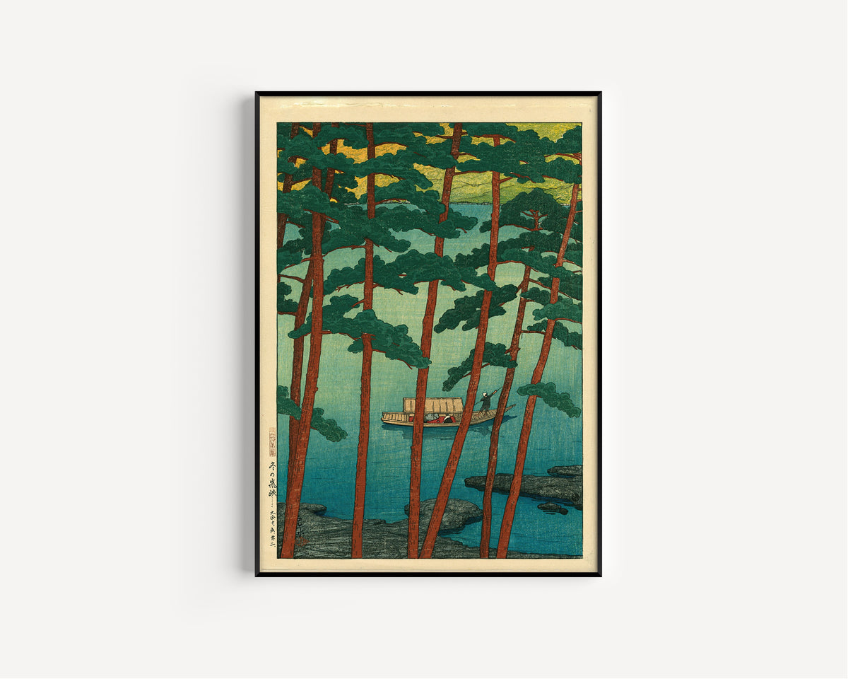 Framed art print of Arashiyama in Winter by Kawase Hasui, in a slim black frame on a plain white wall