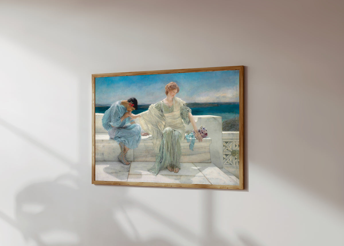 Framed art print of Ask Me No More by Lawrence Alma-Tadema, in a light wood frame on a sunlit white wall, seen at a slight angle