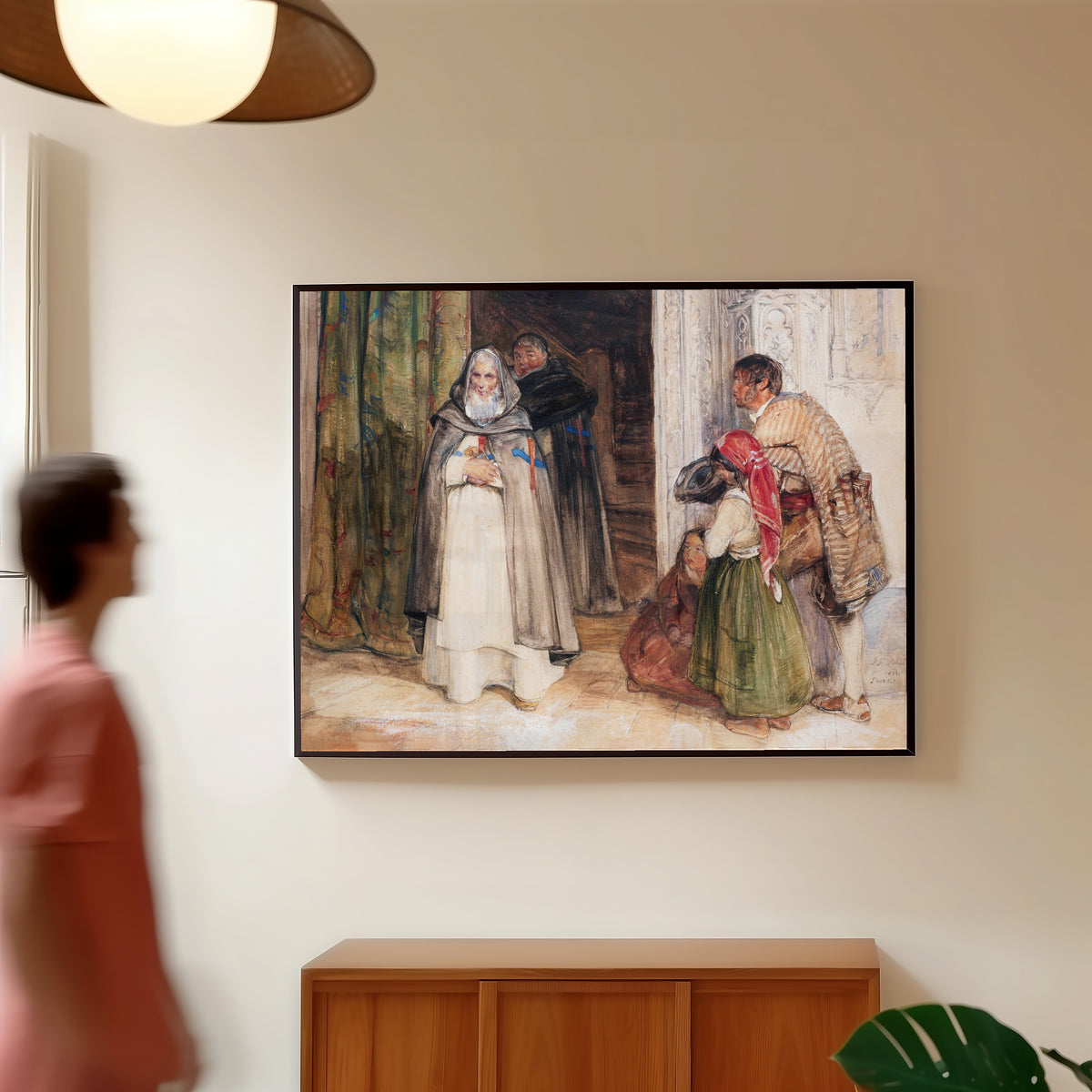 Framed art print of Asking for Alms by John Frederick Lewis, in a slim black frame on a warm wall in a sunlit room