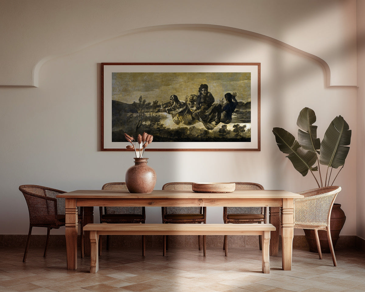 Framed art print of Atropos (The Fates) by Francisco de Goya, above a wooden dining table