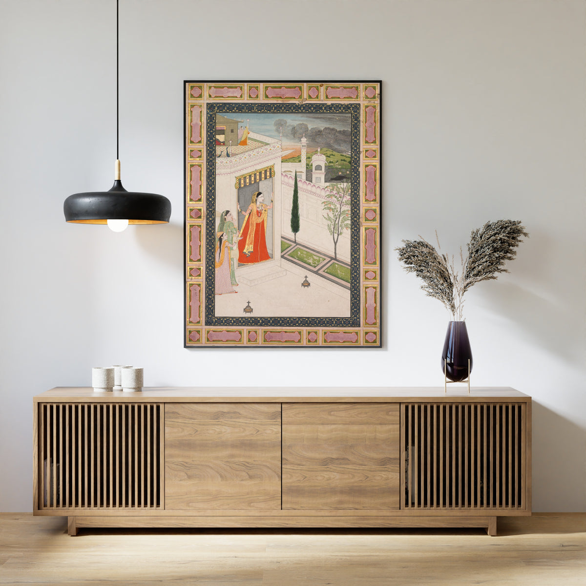 Framed art print of Augury of the crow (Vasakasajja Nayika) by Pahari school, above a slatted wood sideboard