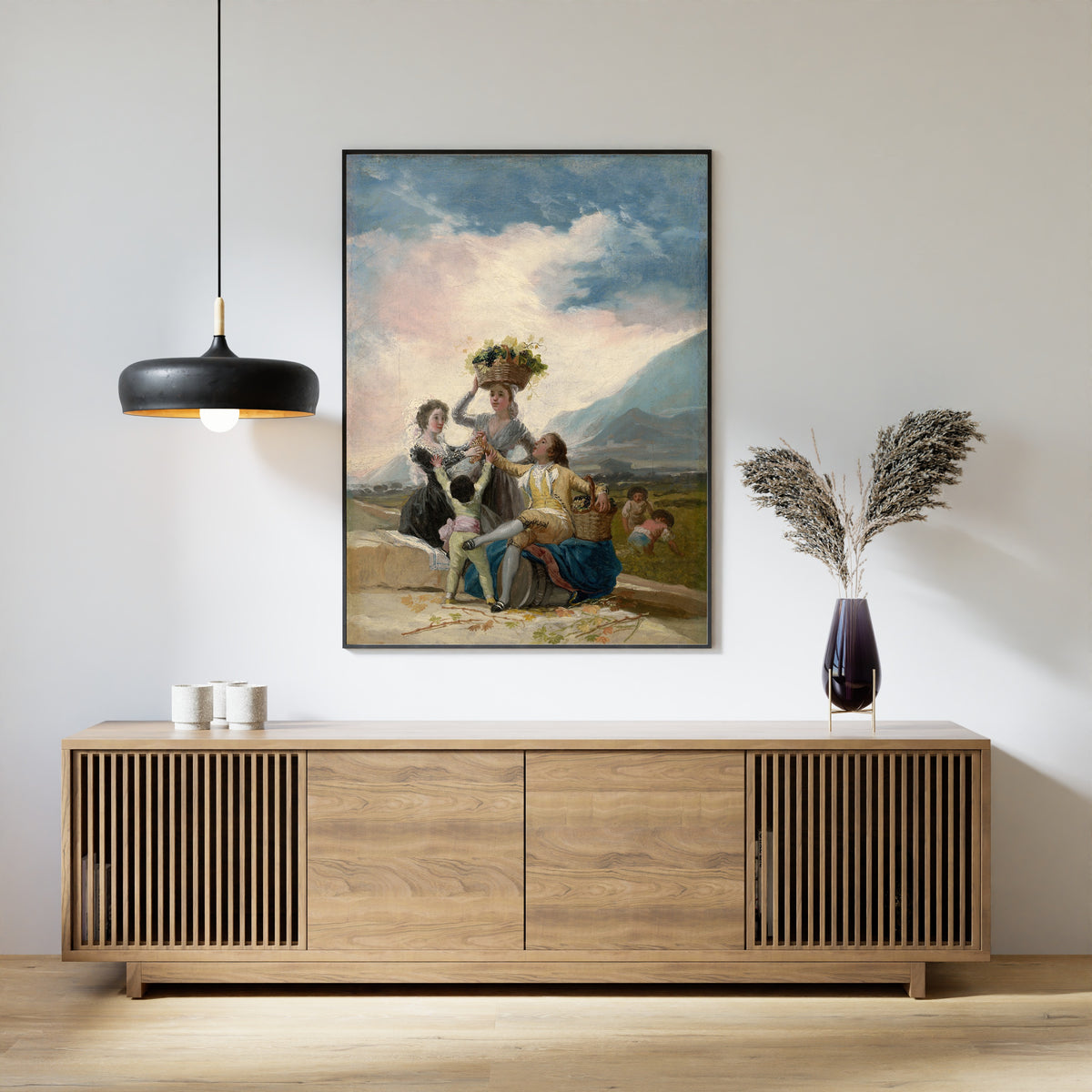 Framed art print of Autumn by Francisco de Goya, above a slatted wood sideboard