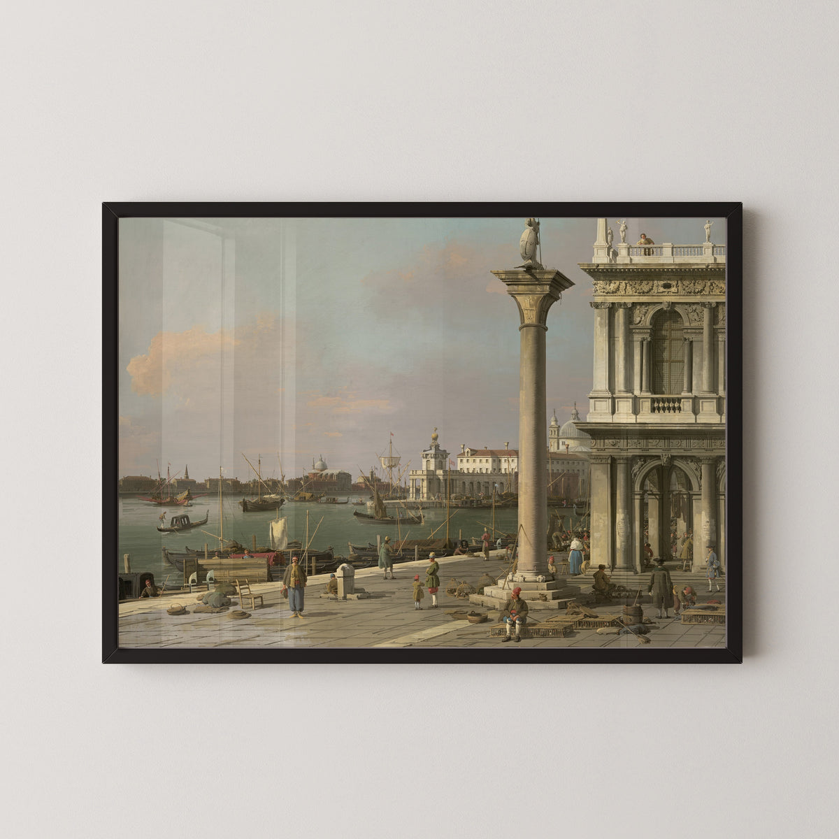 Framed art print of Bacino di S. Marco – From the Piazzetta by Canaletto, in a black frame on a pale wall
