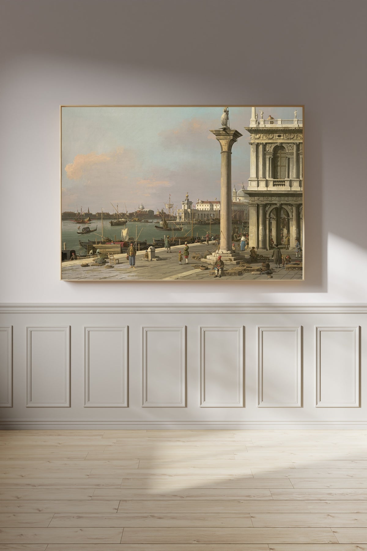Framed art print of Bacino di S. Marco – From the Piazzetta by Canaletto, on a panelled wall in afternoon light