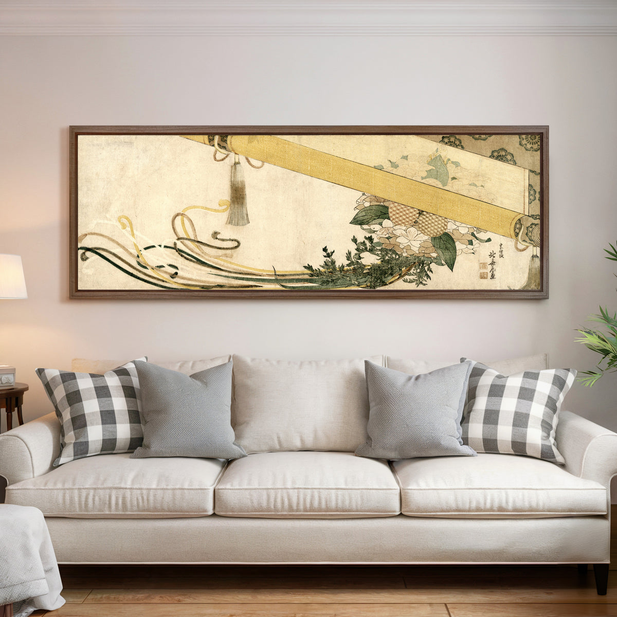 Framed art print of Basket of Flowers with Bamboo Blind by Katsushika Hokusai, above a cream sofa