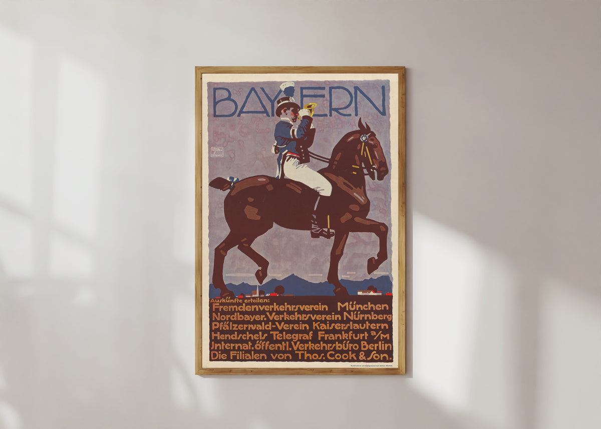 Framed art print of Bayern by Ludwig Hohlwein, in a light wood frame on a sunlit white wall