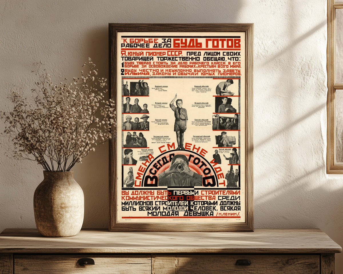 Framed art print of Be ready for the struggle for the workers' cause! Always ready! A…, in a dark wood frame leaning on a rustic console beside dried flowers