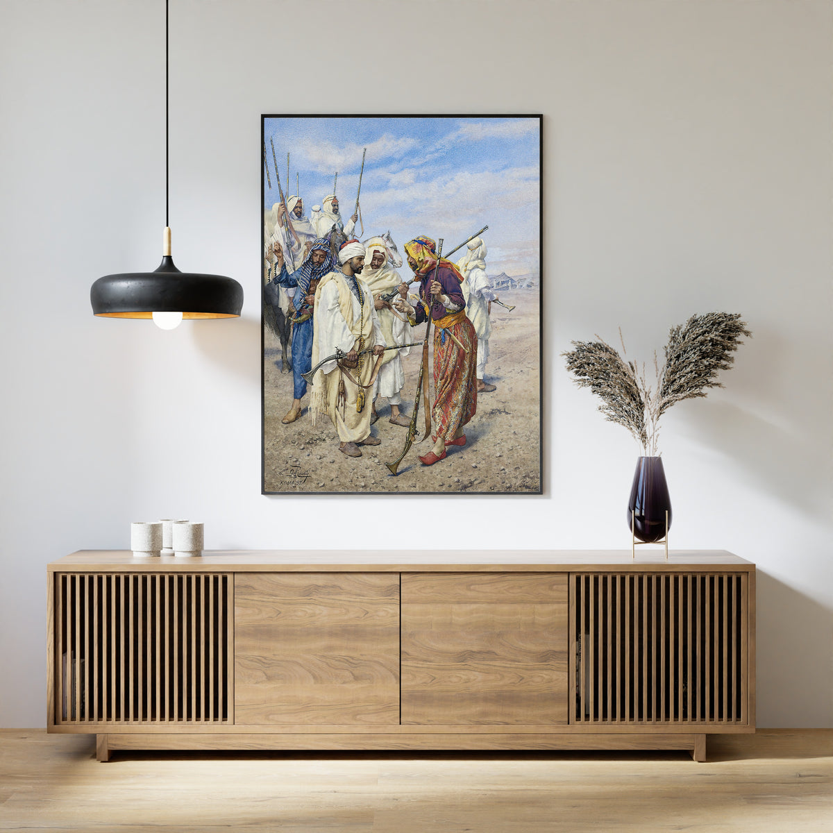 Framed art print of Bedouins Preparing a Raiding Party by Giulio Rosati, above a slatted wood sideboard