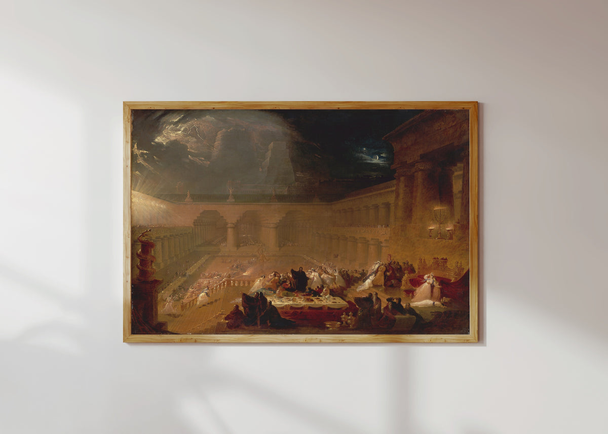 Framed art print of Belshazzar's Feast by John Martin, in a light wood frame on a sunlit white wall