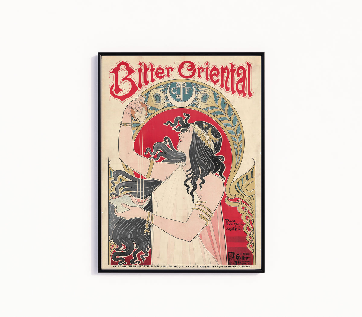 Framed art print of Bitter Oriental by Henri Privat-Livemont, in a slim black frame on a plain white wall