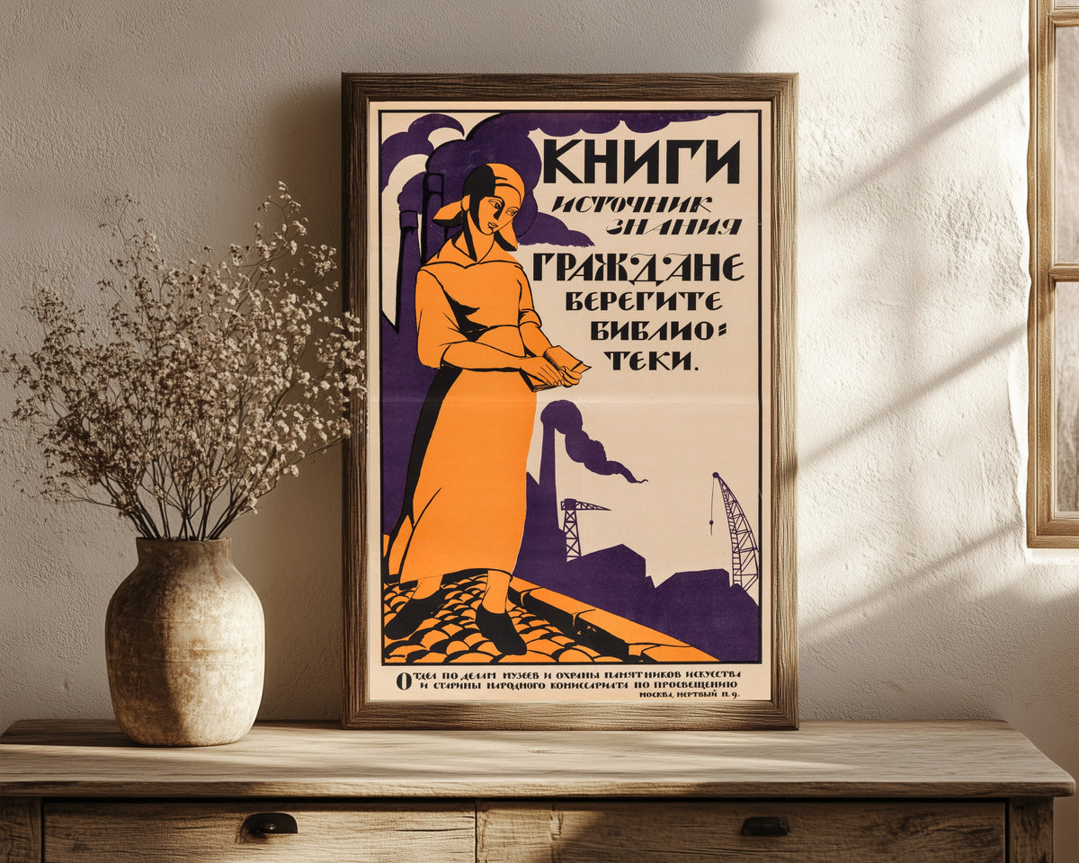 Framed art print of Books are the source of knowledge. Citizens… by Nikolai Kupreyanov, in a dark wood frame leaning on a rustic console beside dried flowers