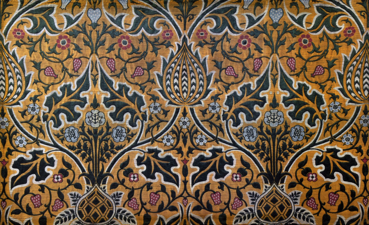 Brocatel by William Morris — Dark green foliage and crimson buds on an amber woven ground