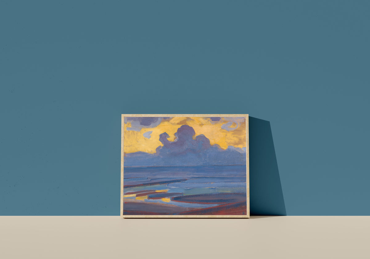 Framed art print of By the Sea by Piet Mondrian, in a light wood frame leaning on a blue wall