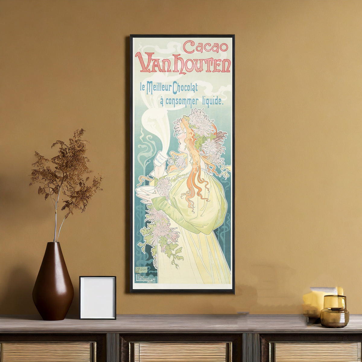 Framed art print of Cacao Van Houten by Henri Privat-Livemont, on an ochre wall above a console table