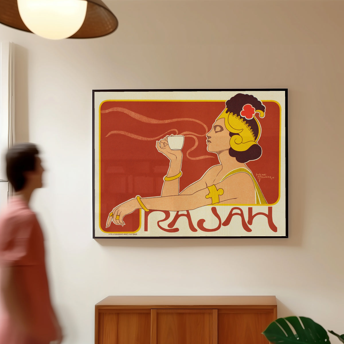 Framed art print of Café Rajah by Henri Meunier, in a slim black frame on a warm wall in a sunlit room