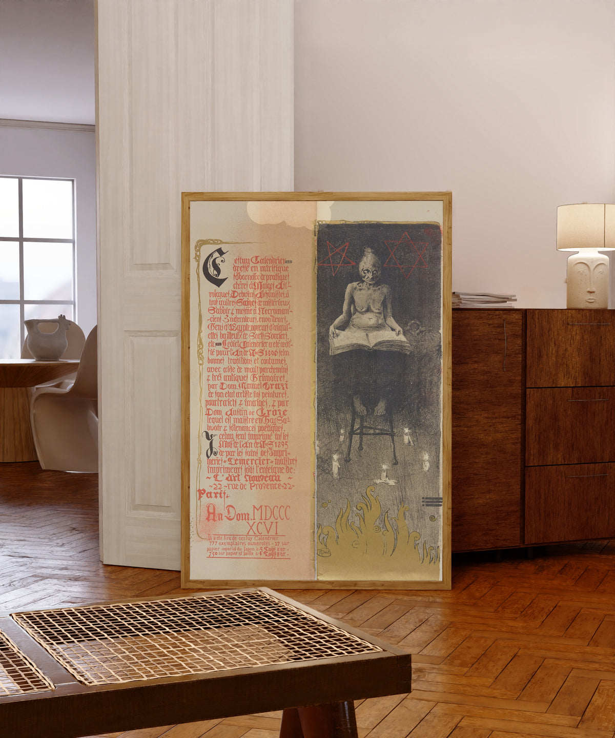 Framed art print of Calendrier magique, Plate 2 by Manuel Orazi, in a light wood frame leaning in a warm room with a parquet floor