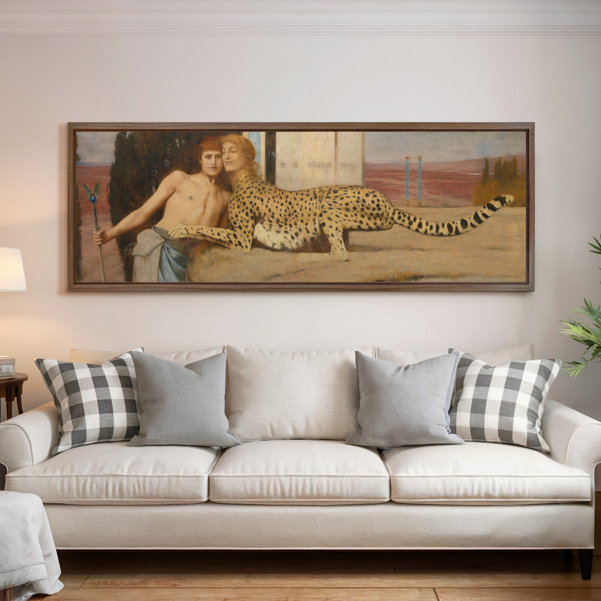 Framed art print of Caresses by Fernand Khnopff, above a cream sofa