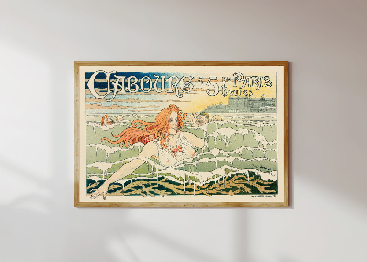Framed art print of Casino de Cabourg by Henri Privat-Livemont, in a light wood frame on a sunlit white wall