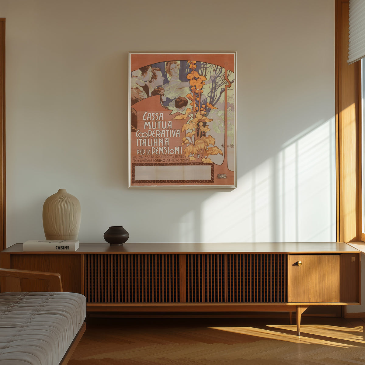 Framed art print of Cassa Mutua Cooperativa Italiana per le Pensioni by Adolfo Hohenstein, in a thin light frame on a sunlit wall above a wooden sideboard
