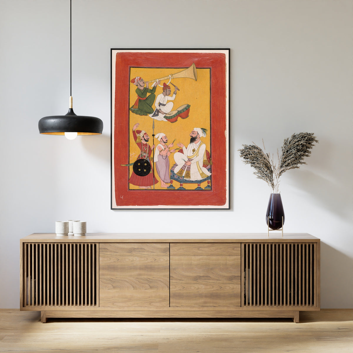 Framed art print of Celebrations of Krishna's Birth, from a Bhagavata Purana by Pahari school, above a slatted wood sideboard